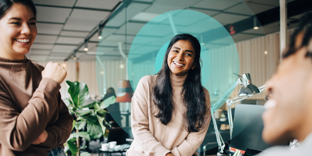 Smiling professional laughing with colleagues in an office setting