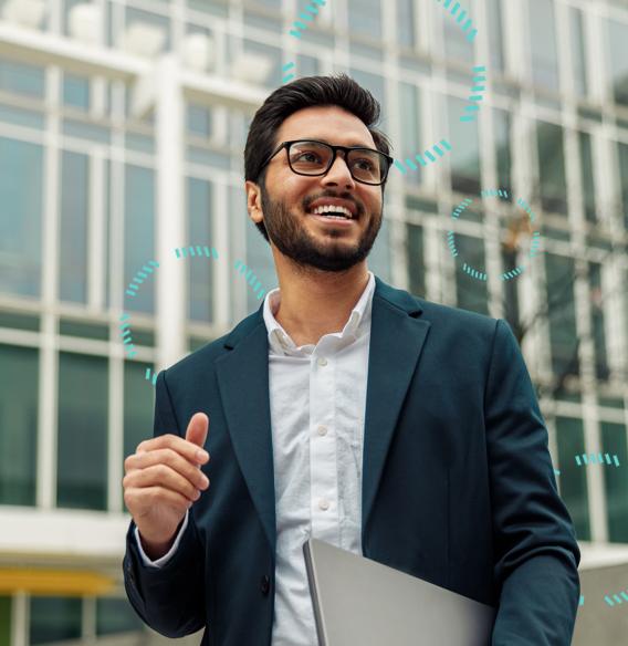 Smiling professional in a suit holding a laptop